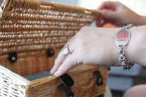 A close-up of a hand selecting items for a gift basket.