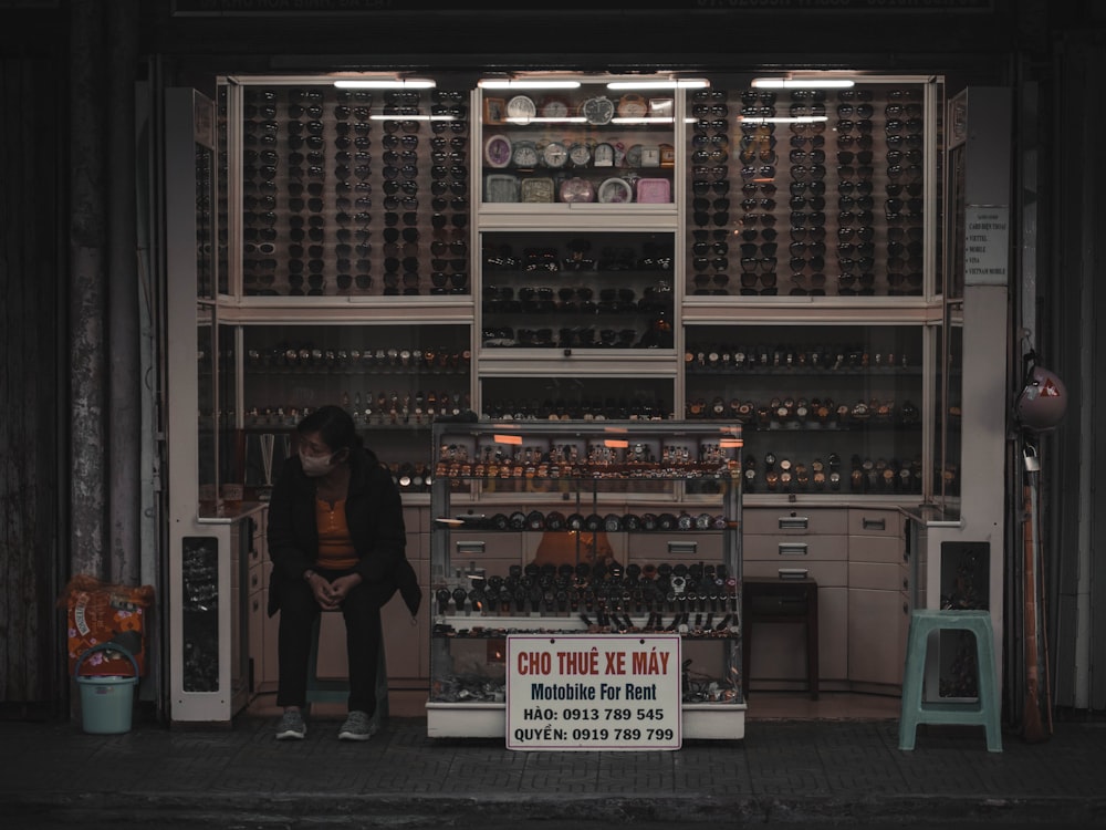 woman in black shirt standing near shelf