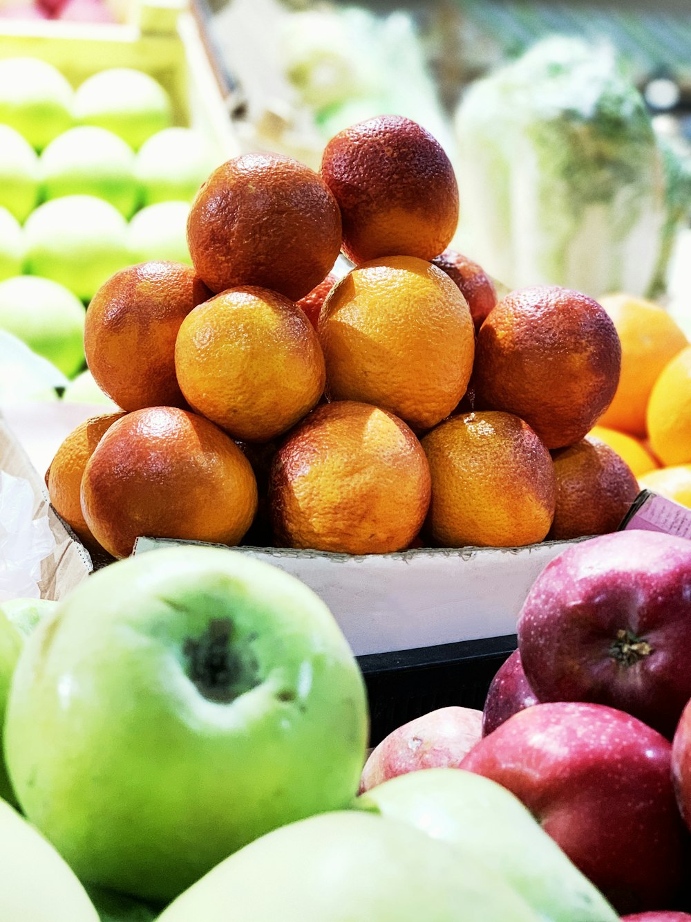 orange and green apples on white plastic tray