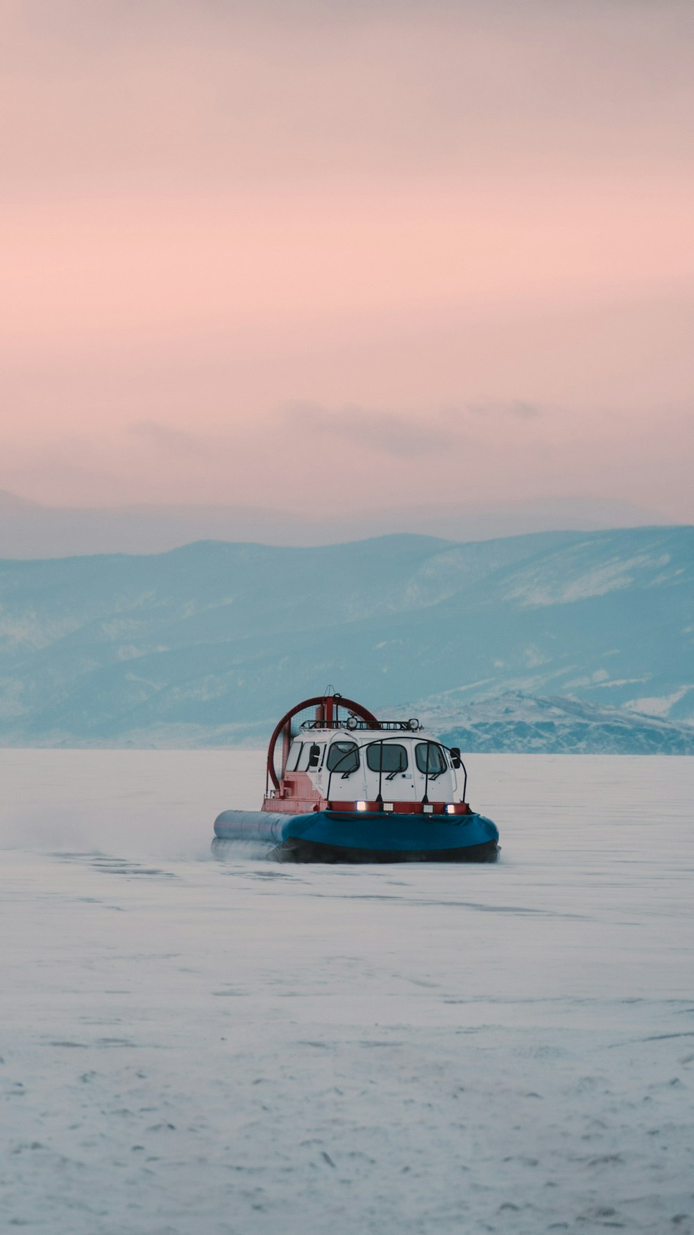 red and white boat on white sand during daytime