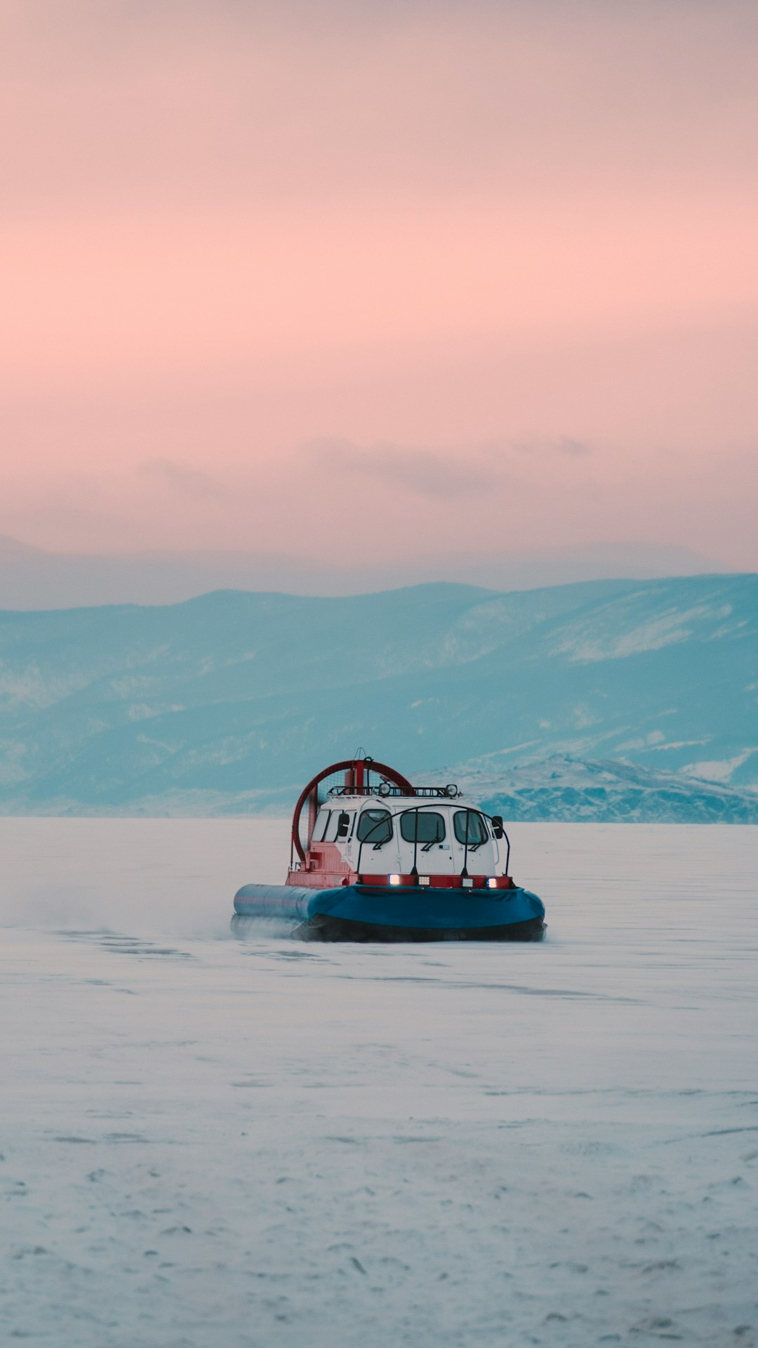 red and white boat on white sand during daytime