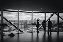 silhouette of people walking on the bridge