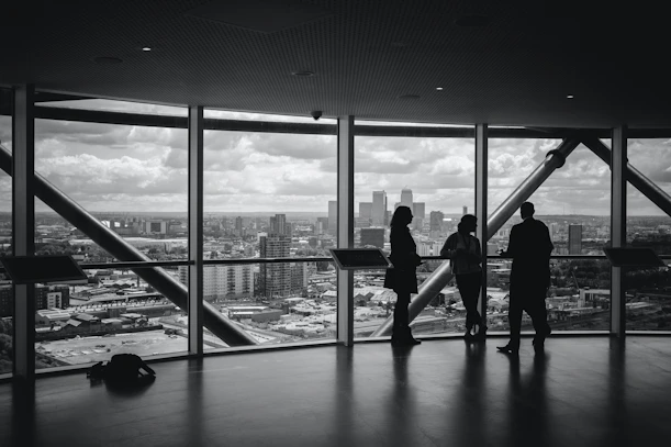 silhouette of people walking on the bridge