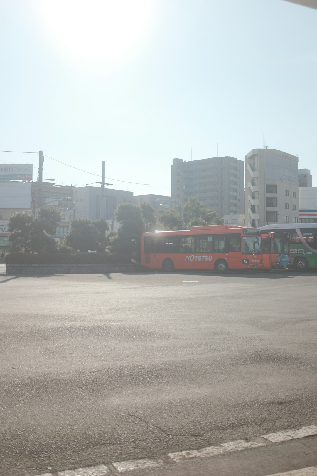 red bus on road during daytime