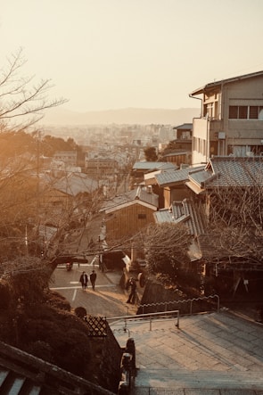Traditional wooden machiya houses lining a quiet Kyoto street at dusk.