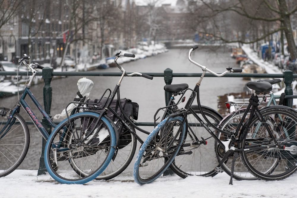 black city bike on snow covered ground during daytime