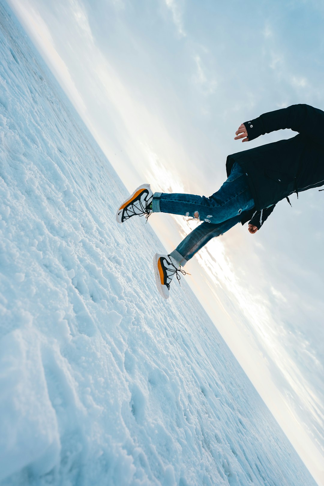 man in black jacket and blue denim jeans doing sky diving during daytime