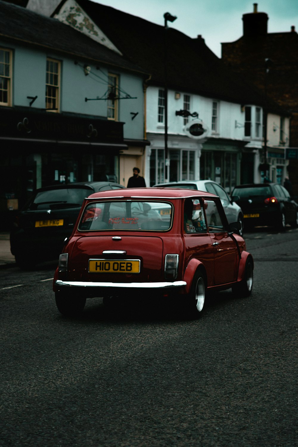 red volkswagen beetle on road during daytime