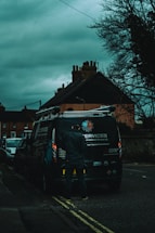 A friendly technician standing beside a cargo van, ready to assist with mobile services.