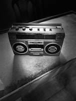 A vintage cassette player set against a retro backdrop.