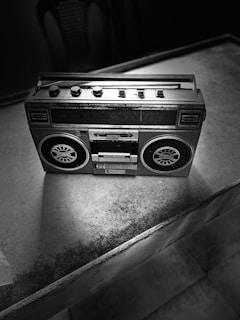 A vintage cassette player set against a retro backdrop.