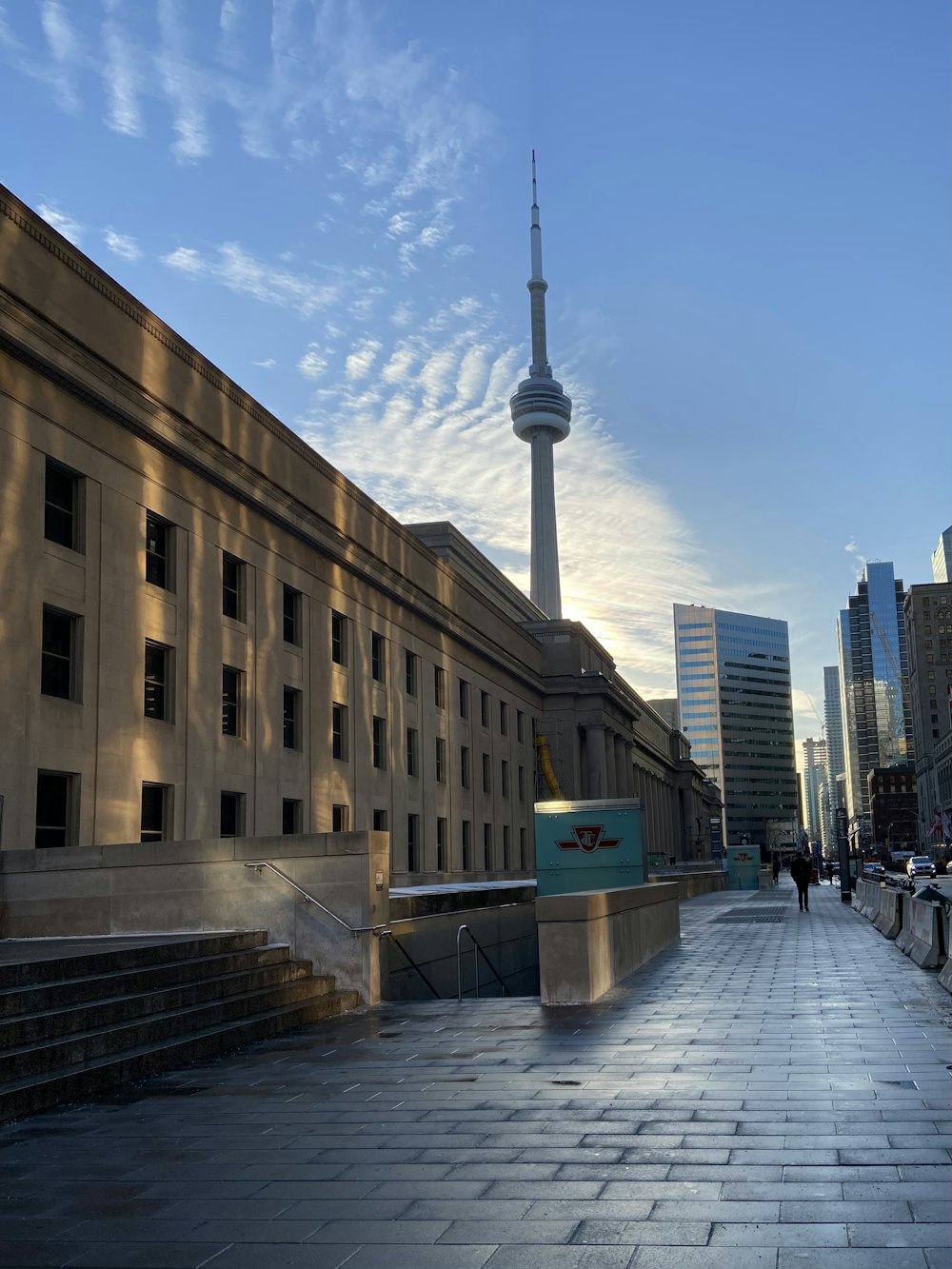 people walking on sidewalk near brown concrete building during daytime