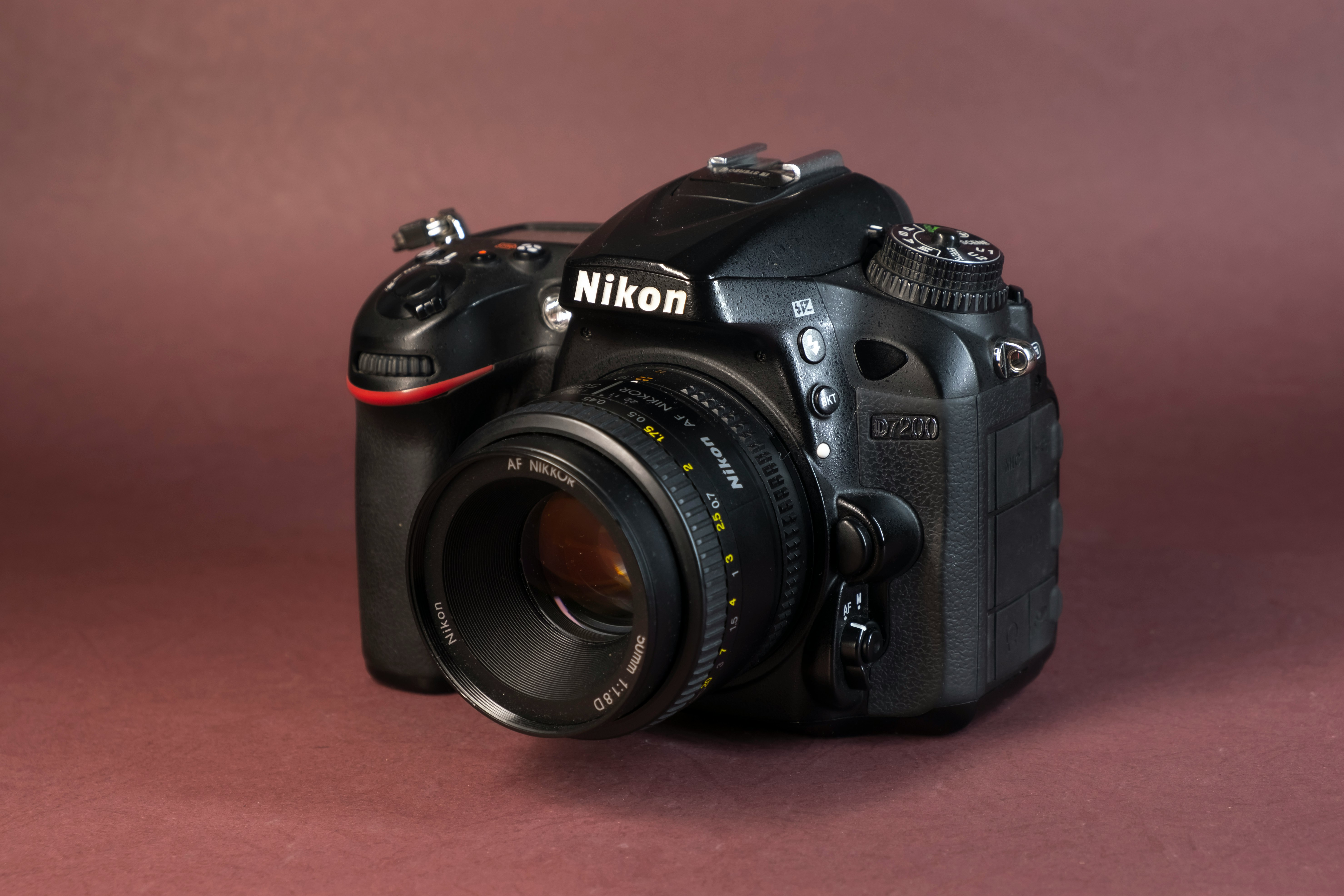 black nikon dslr camera on brown wooden table