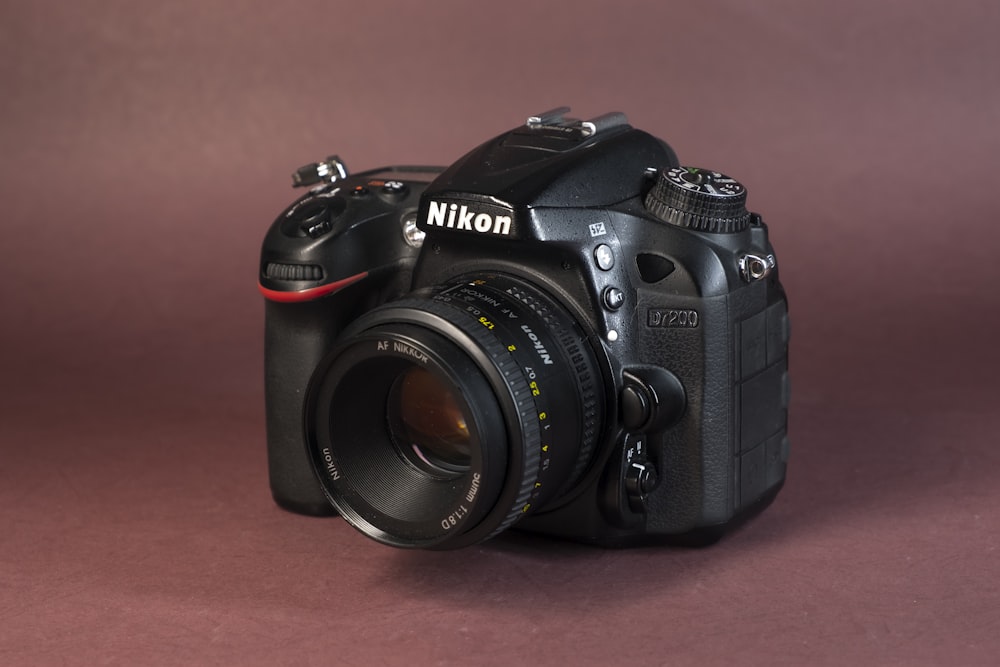 black nikon dslr camera on brown wooden table