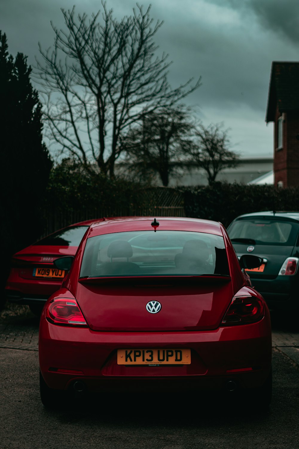 red honda car parked on the side of the road