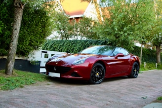 A sleek car parked in a driveway, symbolizing auto insurance.