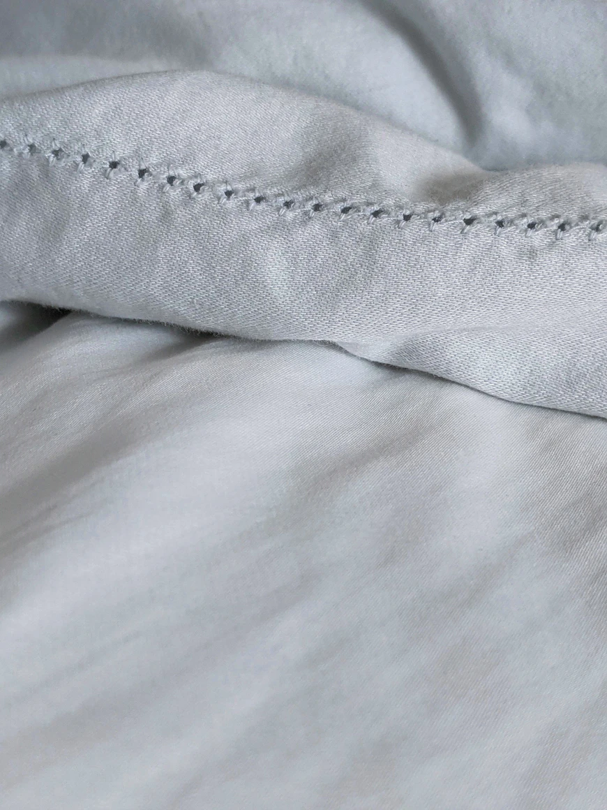 Fine French bed linens, neatly turned