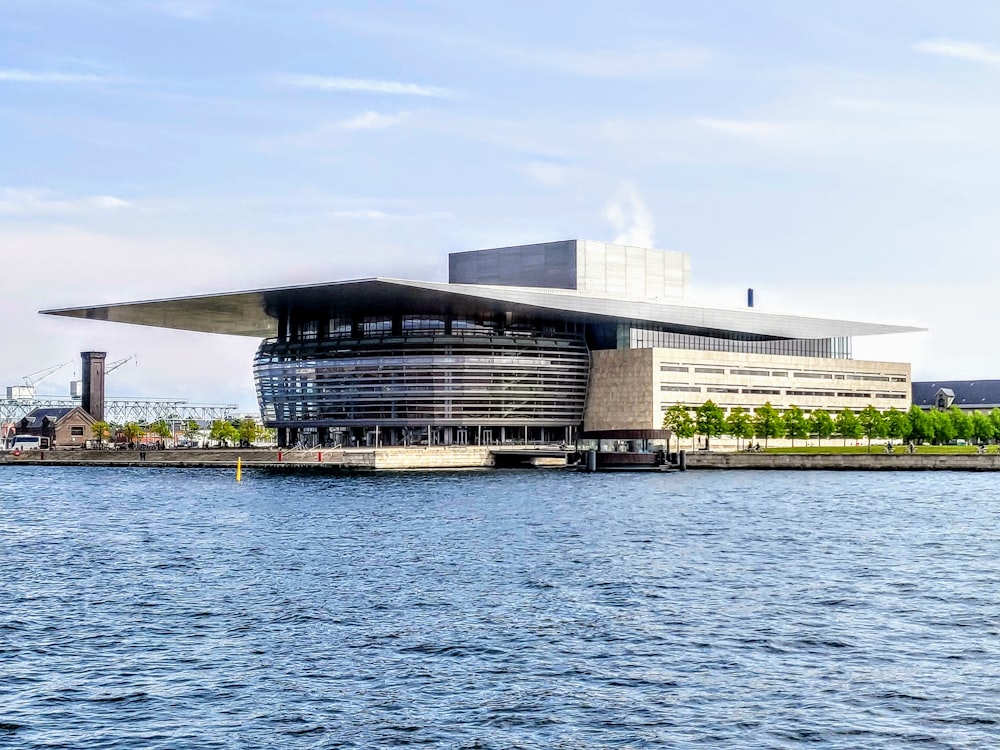 white and black building near body of water during daytime