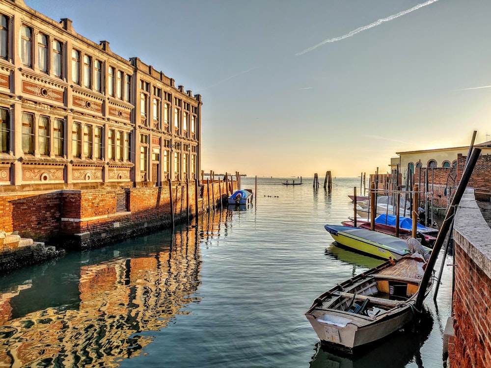 boat on dock near buildings during daytime