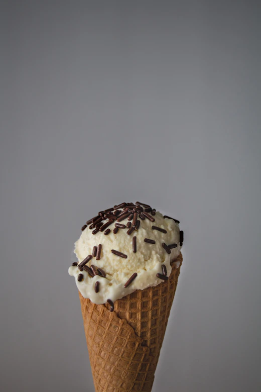 Mint green gelato with chocolate chips in a cup