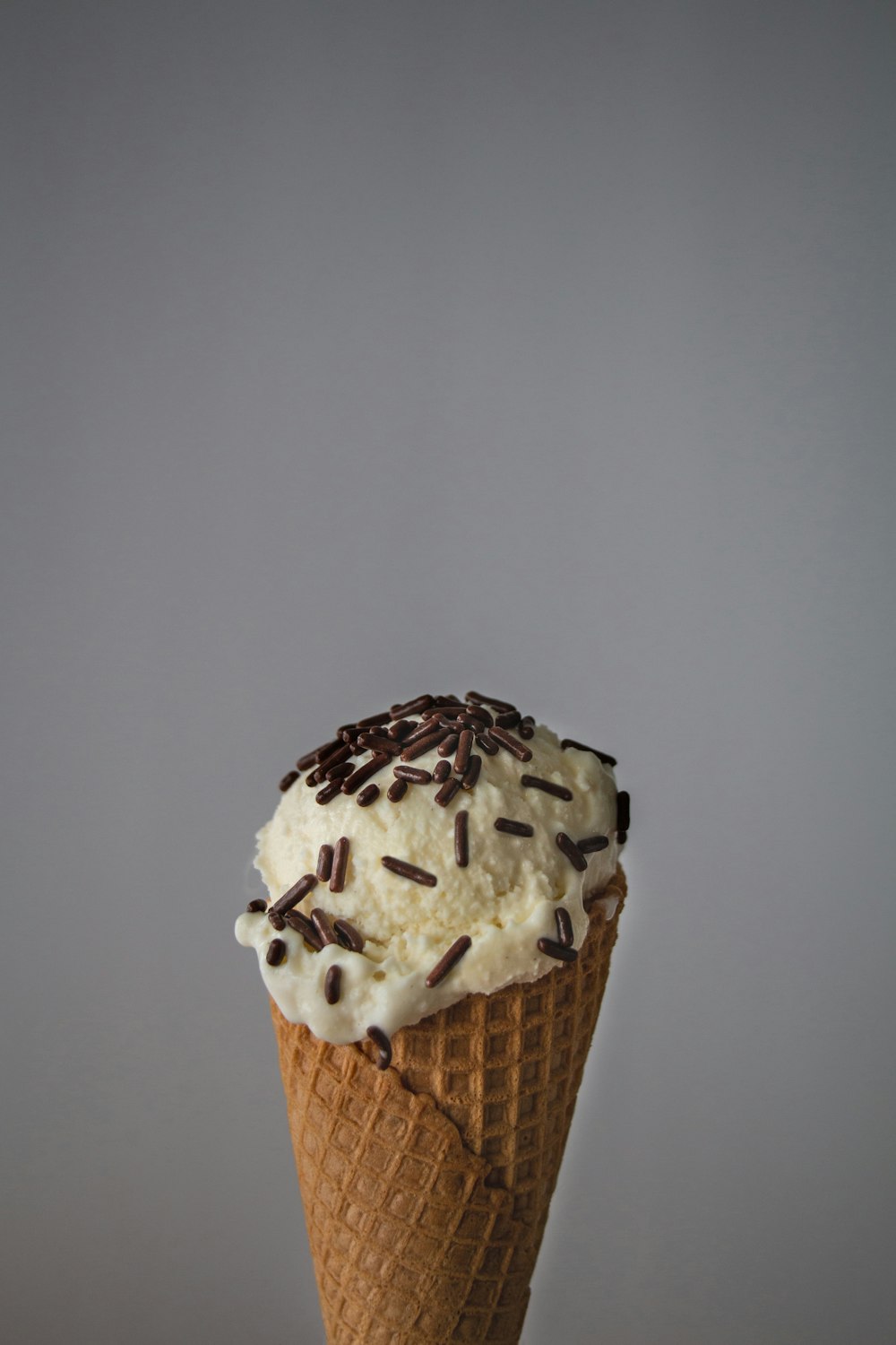 white ice cream on brown cone