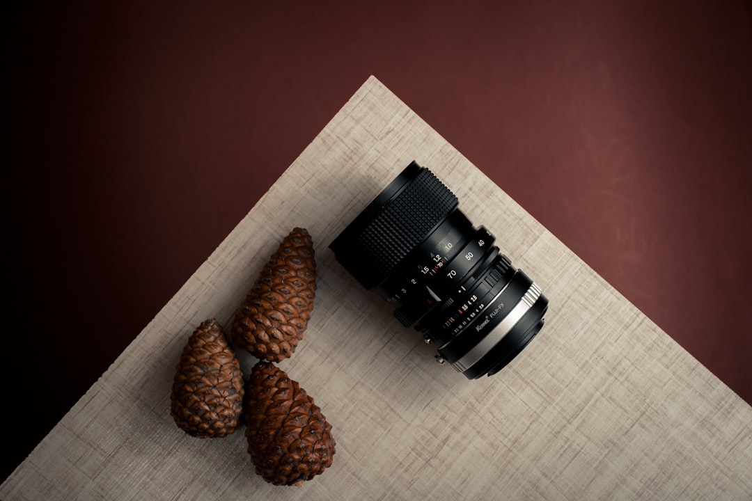 black dslr camera lens on brown wooden table