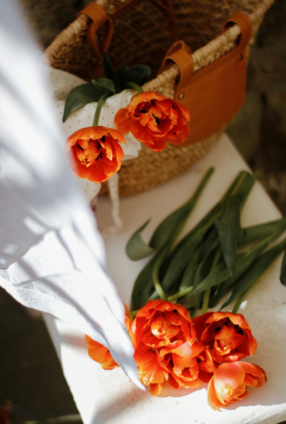 orange roses bouquet on white textile