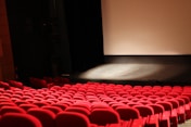 red chairs in front of white projector screen