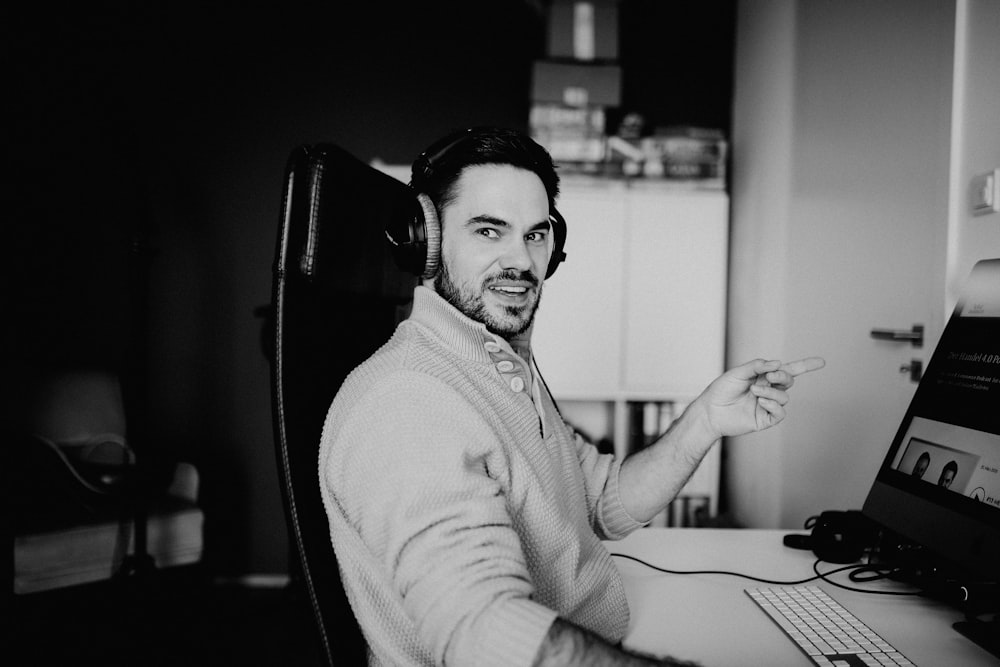 man in sweater sitting on chair