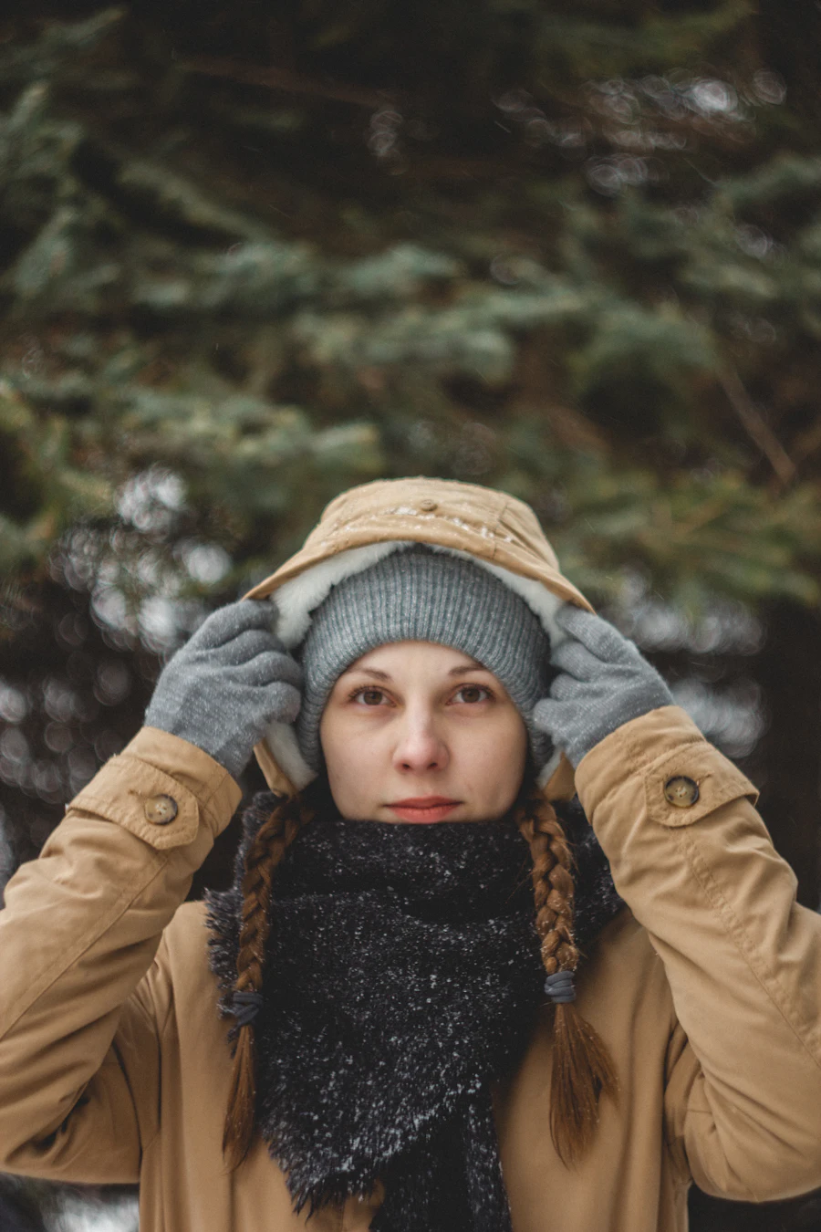A person bundled warmly in a knit toque and coat in the Canadian winter