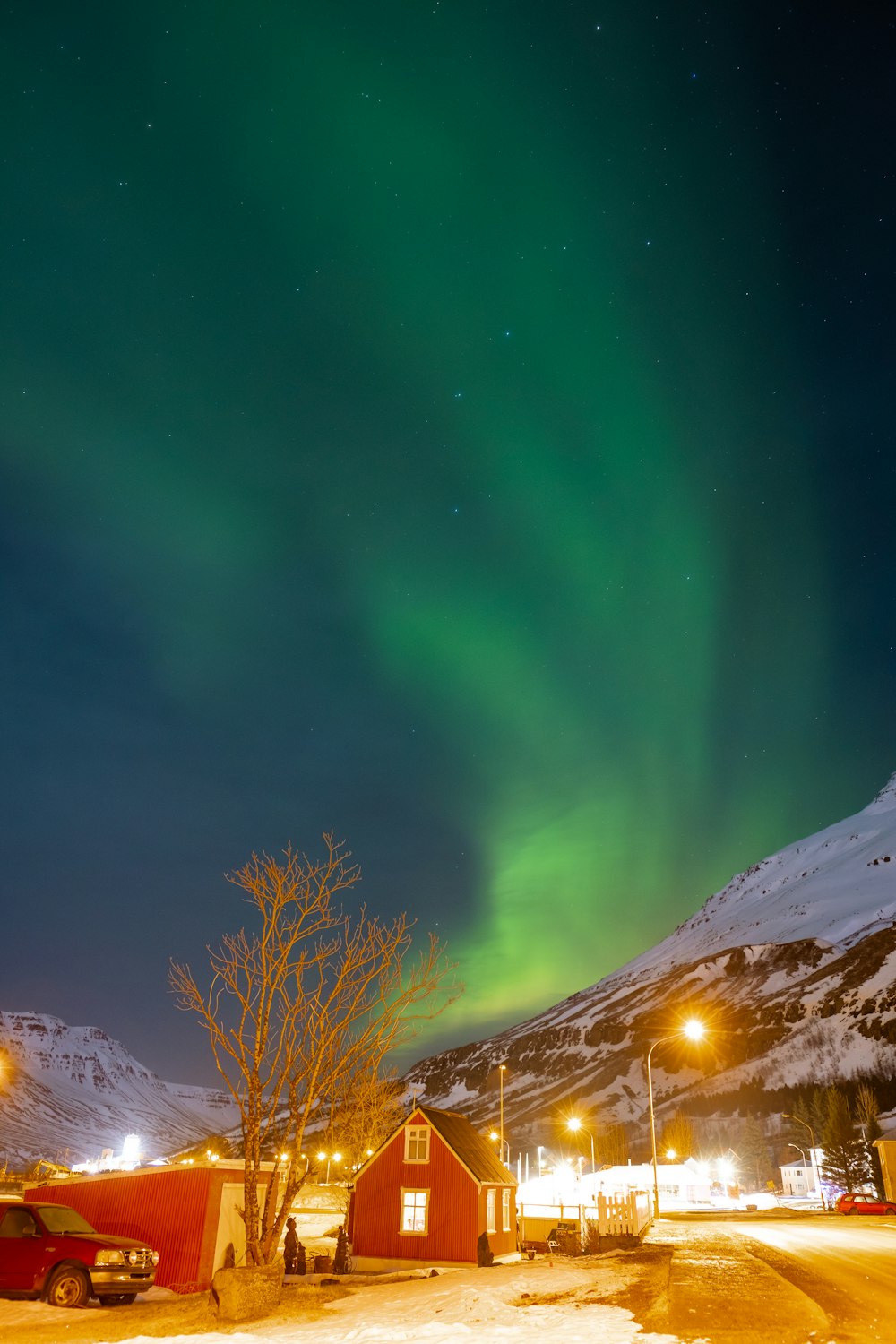 snow covered mountain under green sky