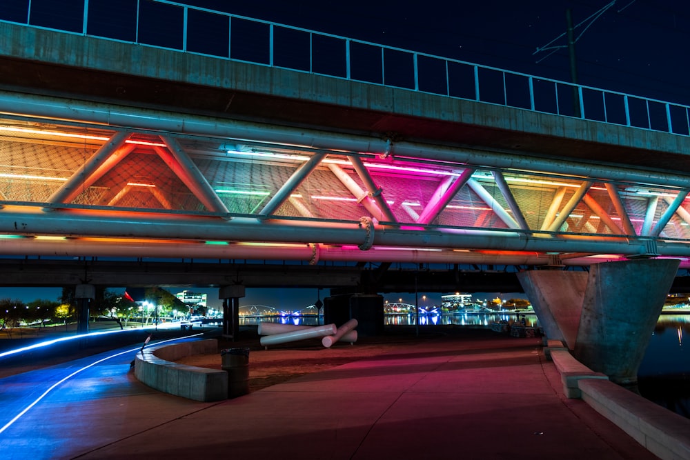 green and red lighted bridge during night time