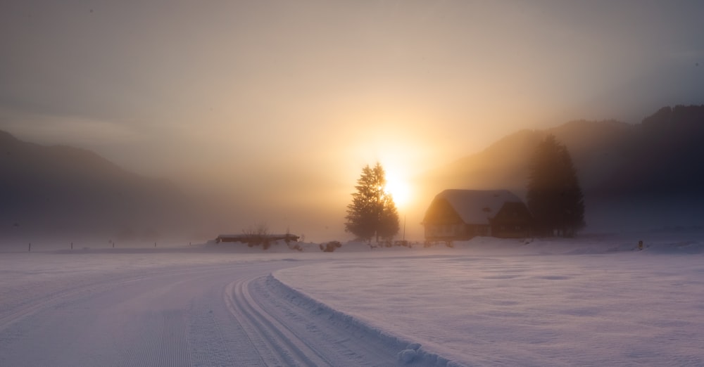 snow covered field during sunset