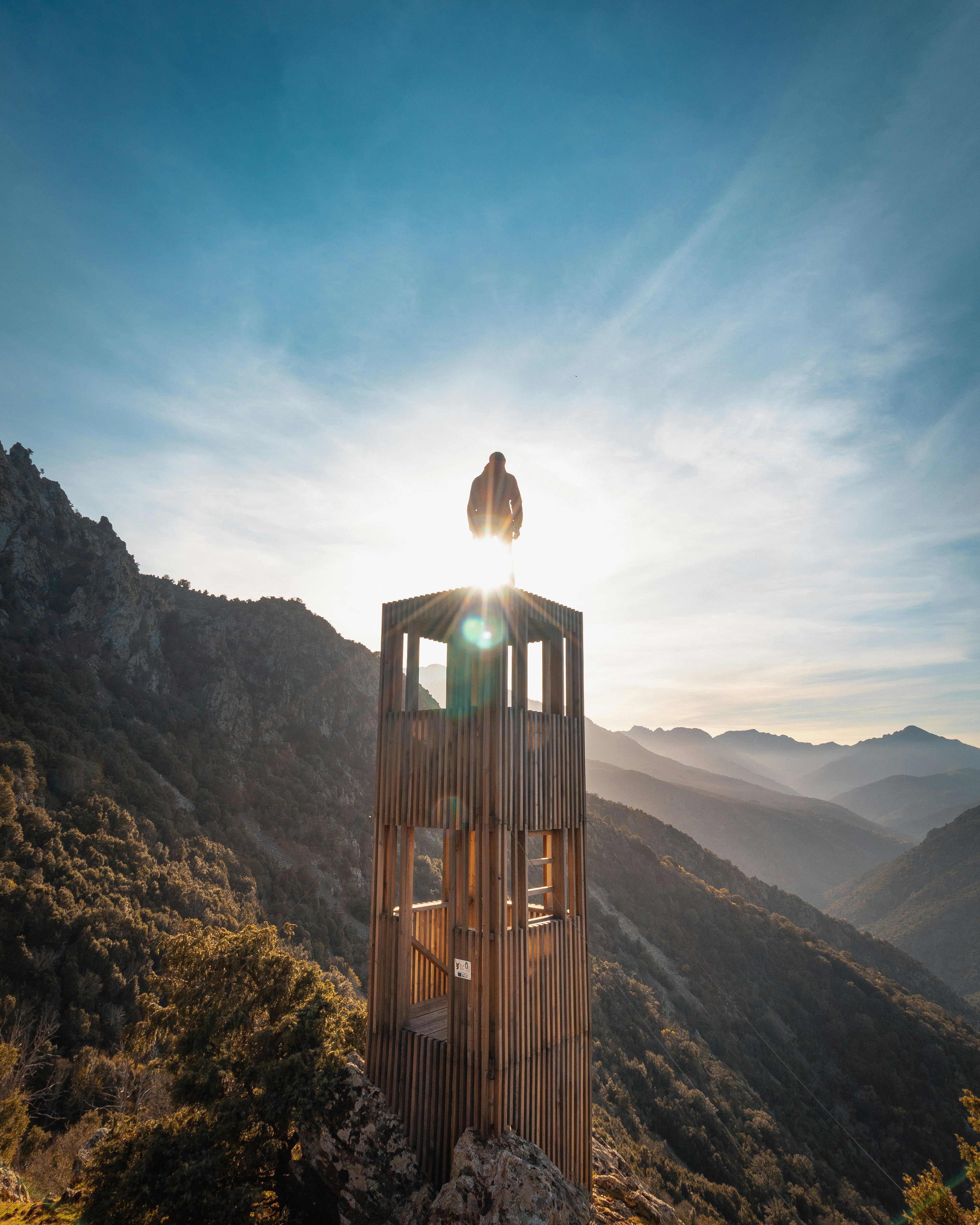 brown wooden tower on mountain during daytime