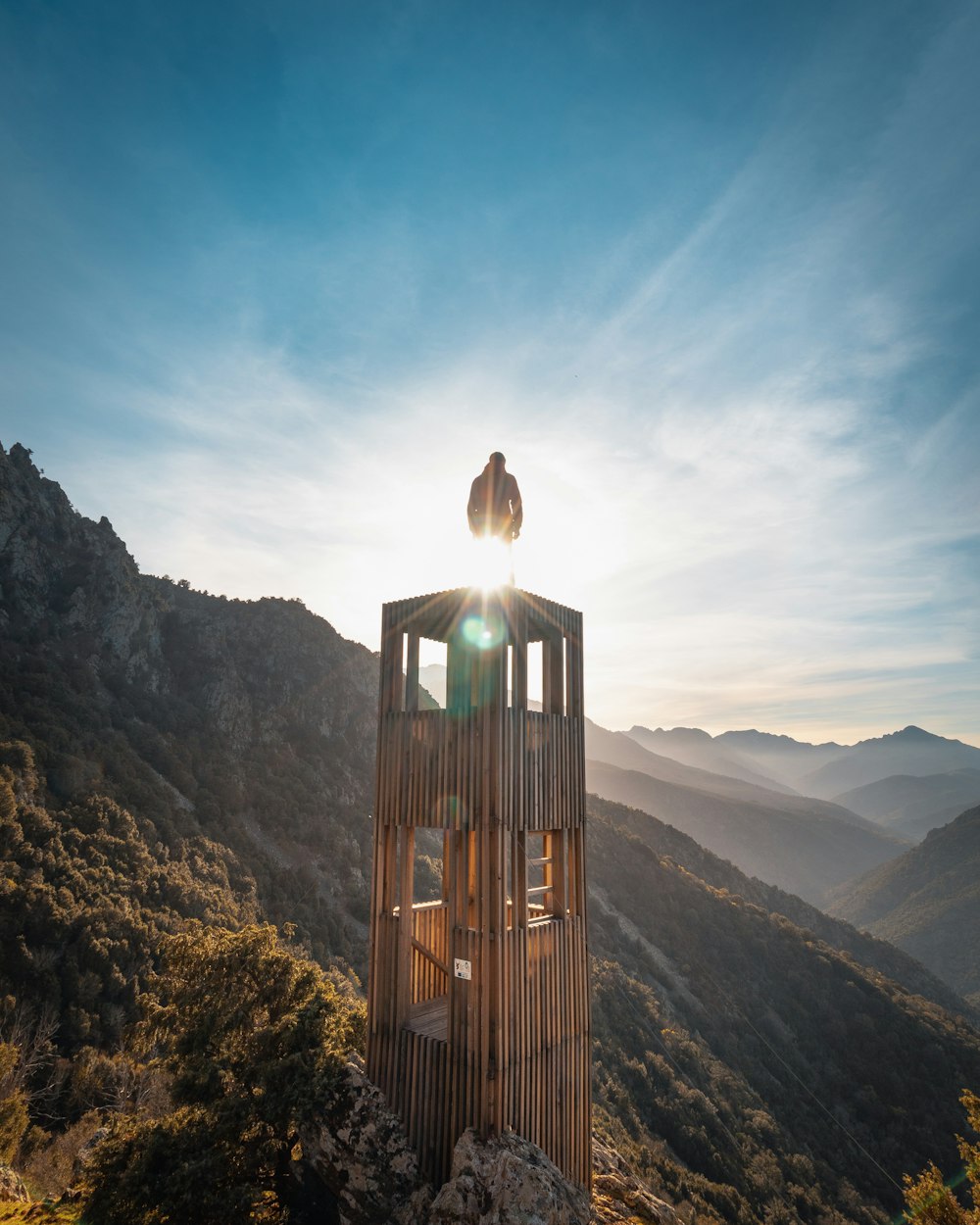 brown wooden tower on mountain during daytime