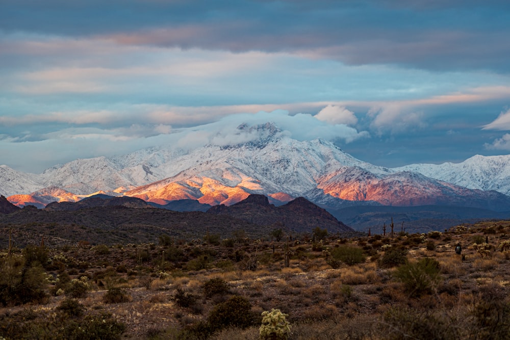 brown and white mountains under white clouds during daytime