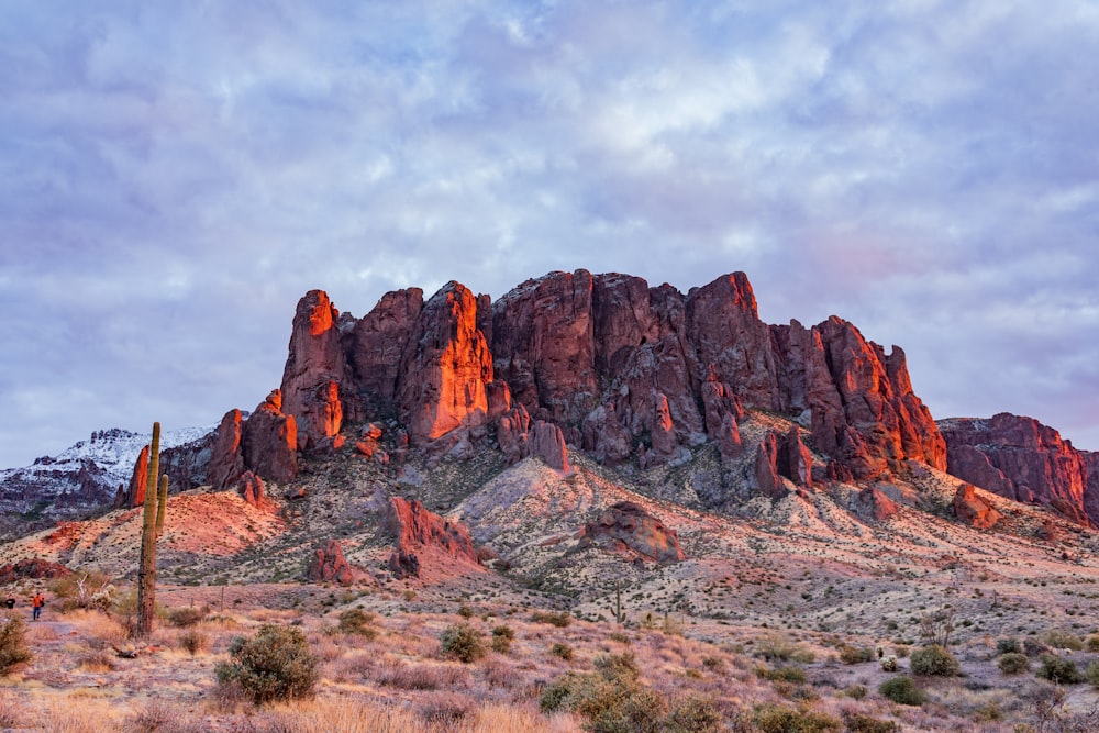 brown rock formation under white clouds during daytime