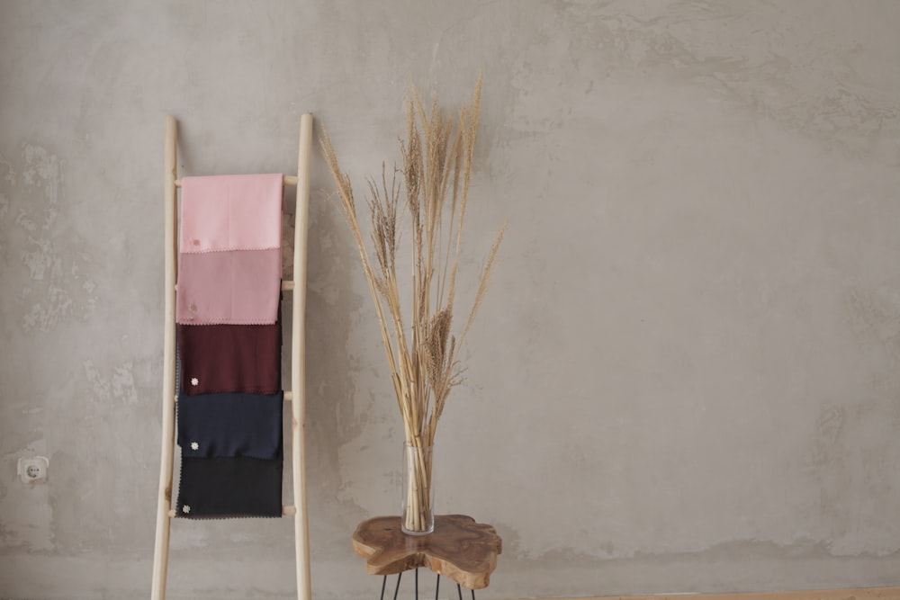 brown broom leaning on white wall