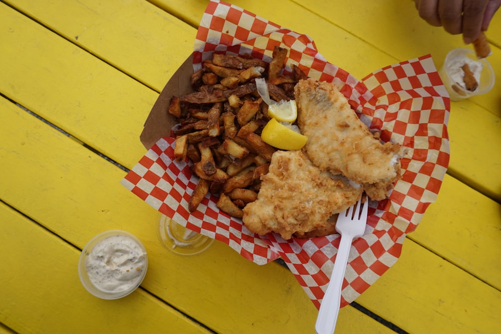 fried chicken on red and white checkered paper plate