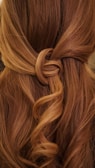 brown hair on white textile
