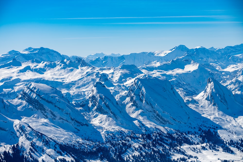 snow covered mountains under blue sky during daytime