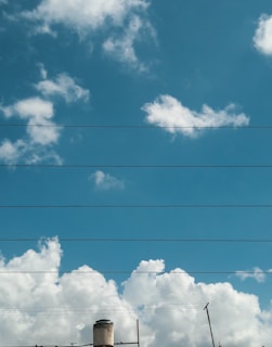 Modern energy infrastructure with power lines and a natural gas pipeline under a clear sky.