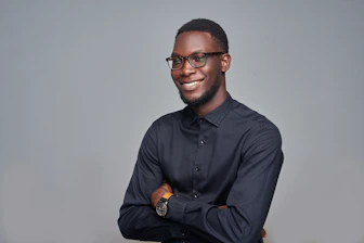 man in black dress shirt wearing black framed eyeglasses