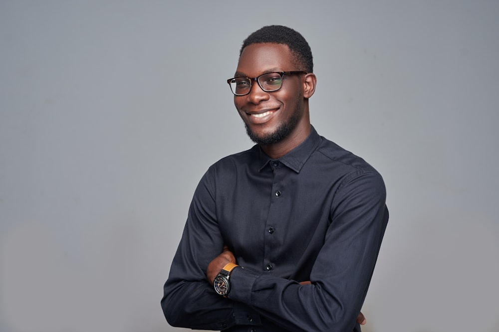 man in black dress shirt wearing black framed eyeglasses