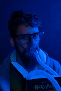 man in black framed eyeglasses and white jacket
