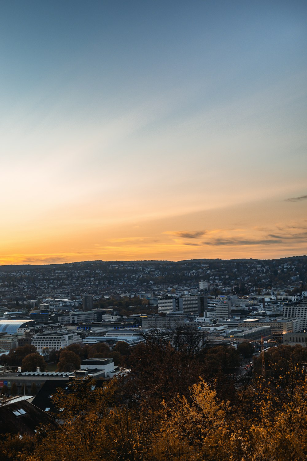 city with high rise buildings under orange sky during sunset