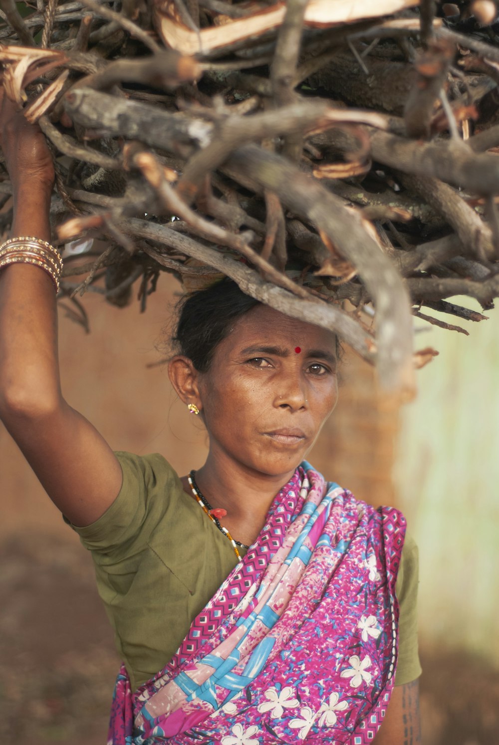 woman in green shirt wearing silver bracelet