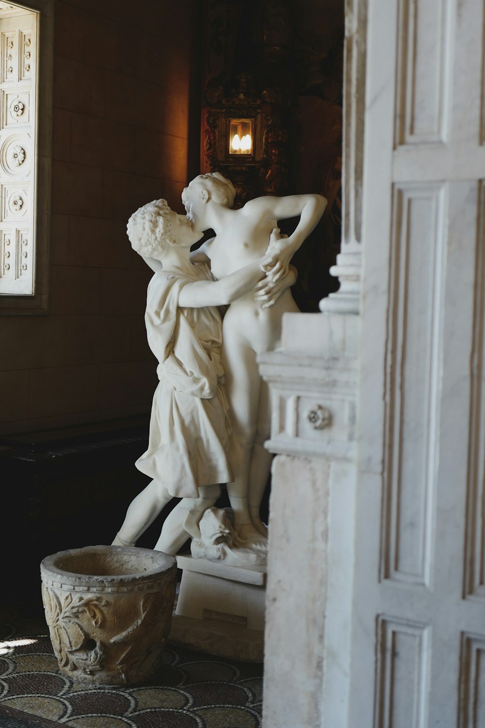 white concrete statue of man and woman