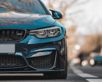 blue bmw car on road during daytime