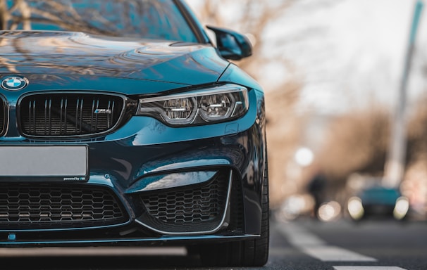 blue bmw car on road during daytime